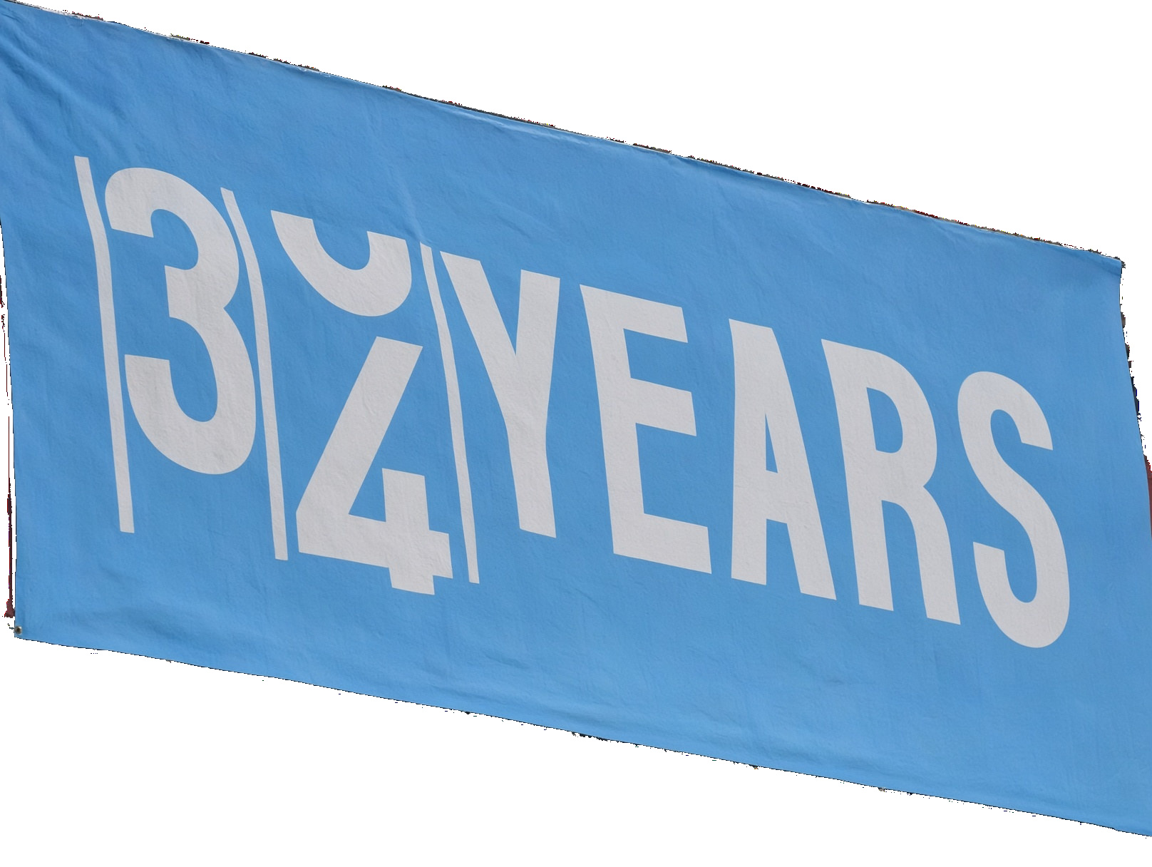 A sky-blue cloth banner on white. The numeral 3 is set above the numeral 4, then the word YEARS.